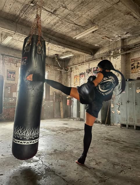 Vessel training imagery: a woman working at a heavy bag in the gym